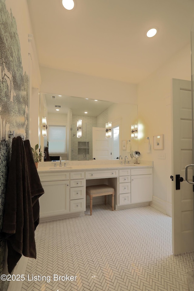 full bath with recessed lighting, a sink, baseboards, and double vanity