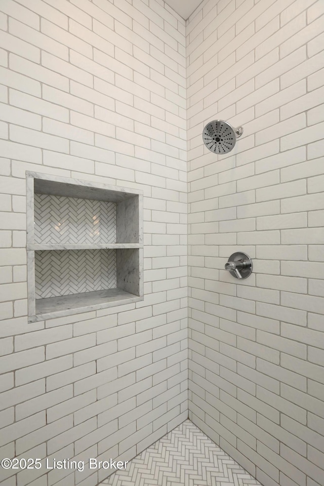 bathroom with tiled shower