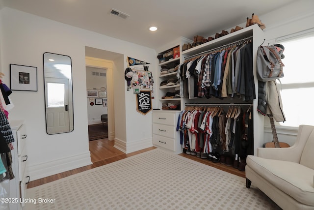 spacious closet with visible vents and wood finished floors