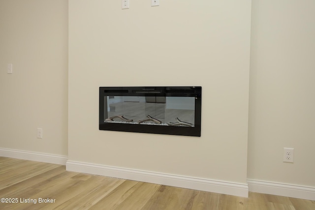 interior details featuring baseboards and wood finished floors