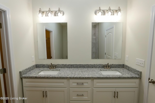 bathroom featuring a sink and double vanity