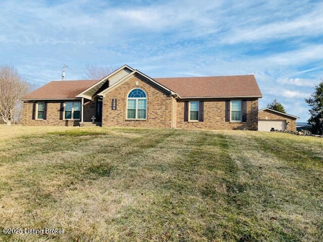 single story home with brick siding and a front lawn