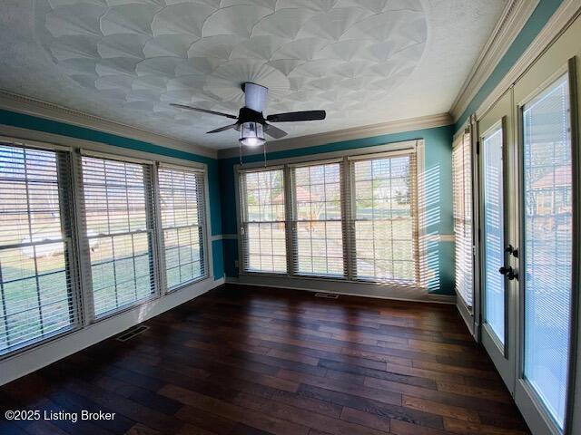 unfurnished sunroom featuring ceiling fan and visible vents