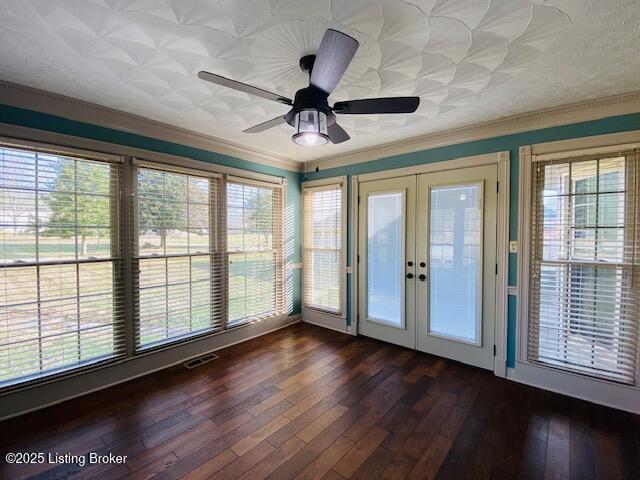 unfurnished sunroom featuring ceiling fan, french doors, plenty of natural light, and visible vents