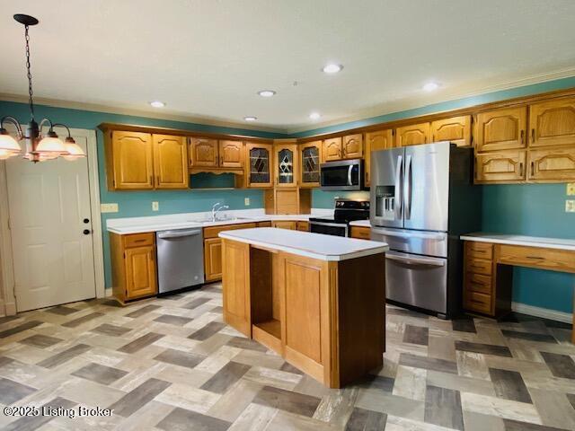 kitchen with stainless steel appliances, brown cabinetry, light countertops, and glass insert cabinets