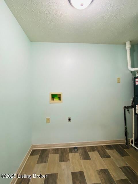 laundry area with laundry area, hookup for a washing machine, hookup for an electric dryer, and wood finished floors