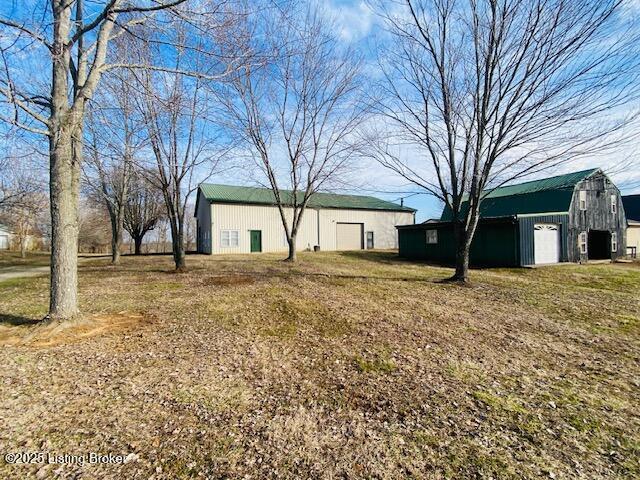 view of yard with an outbuilding and a barn