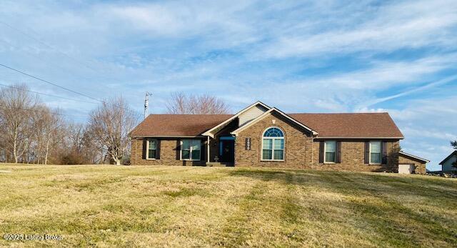 ranch-style home featuring a front yard