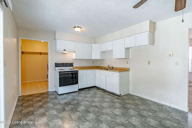 kitchen with white electric range oven, baseboards, white cabinetry, and light countertops