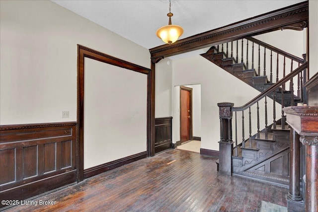 entrance foyer with stairway, dark wood finished floors, and baseboards