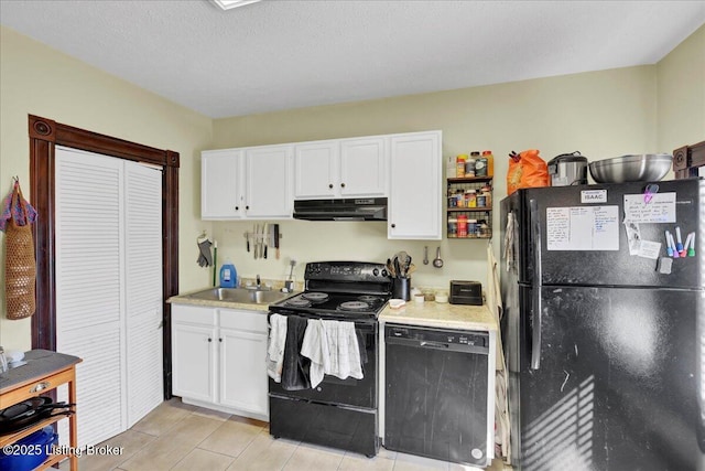 kitchen with under cabinet range hood, a sink, white cabinetry, light countertops, and black appliances