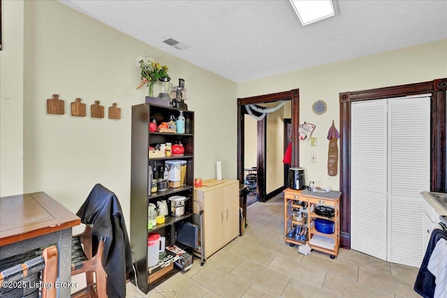 interior space with light tile patterned floors and visible vents