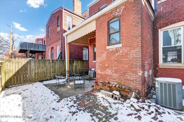 exterior space with cooling unit and fence