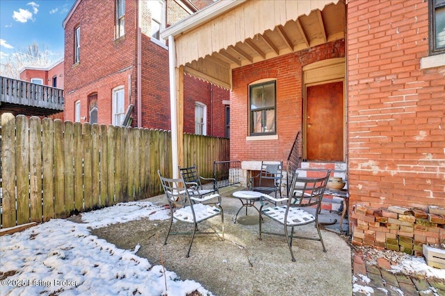 snow covered patio with entry steps and fence