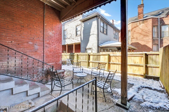 snow covered patio with fence