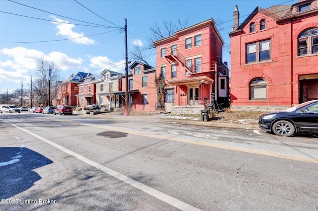 view of street with curbs, sidewalks, and a residential view