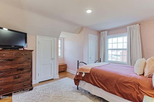 bedroom featuring light wood-style floors and baseboards