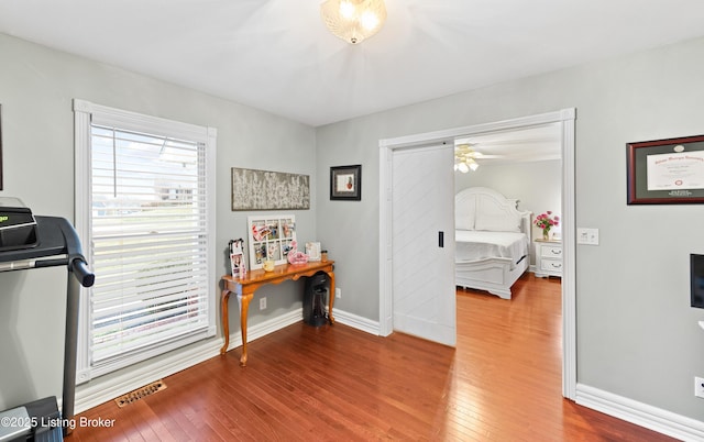 interior space with washer / clothes dryer, visible vents, baseboards, and hardwood / wood-style flooring