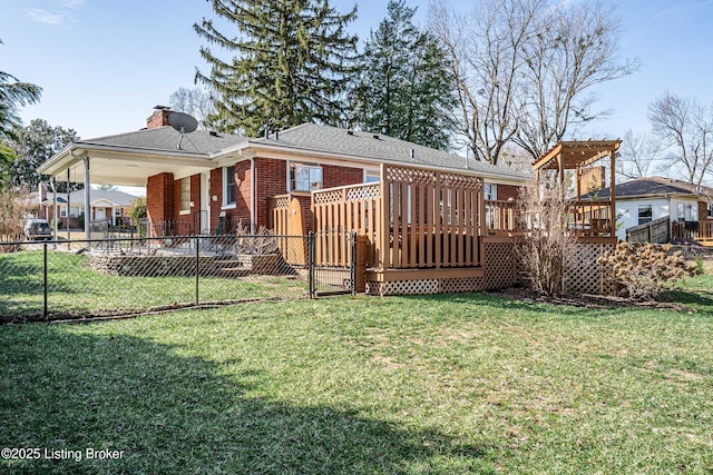 rear view of property featuring brick siding, a lawn, fence, and a wooden deck