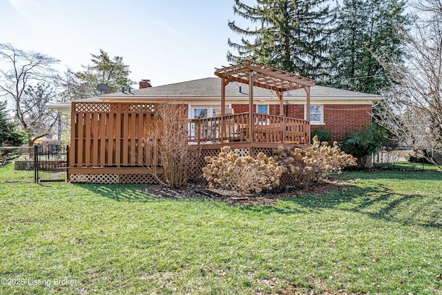 back of house featuring a lawn, fence, a deck, a pergola, and brick siding