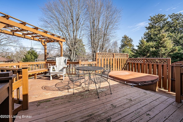 wooden deck with a pergola, a covered hot tub, and outdoor dining space