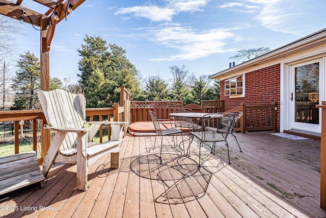 wooden deck featuring outdoor dining area and a pergola