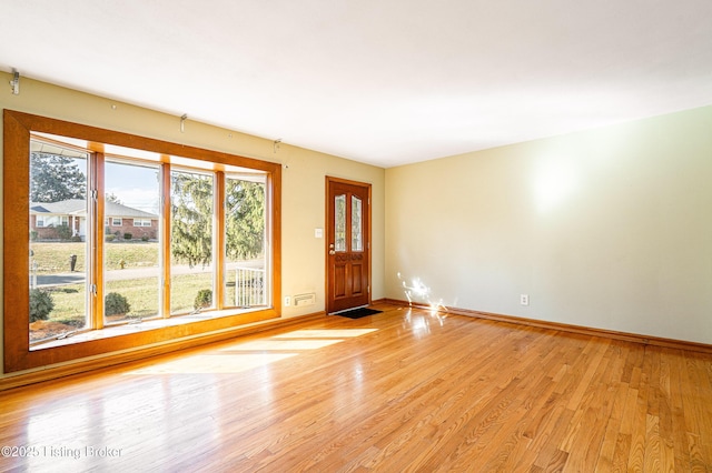 unfurnished room featuring light wood-style flooring and baseboards