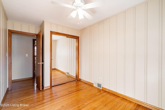 spare room with visible vents, ceiling fan, and light wood-style flooring