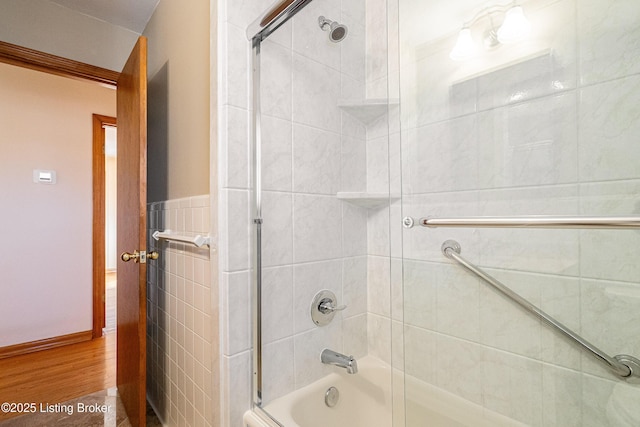 full bathroom featuring enclosed tub / shower combo and wood finished floors