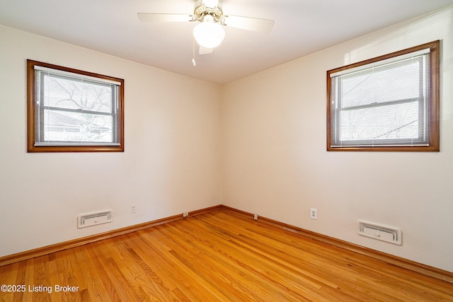 unfurnished room featuring light wood-style floors, ceiling fan, and baseboards