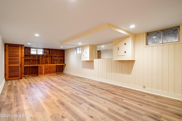 below grade area featuring baseboards, wood finished floors, and recessed lighting