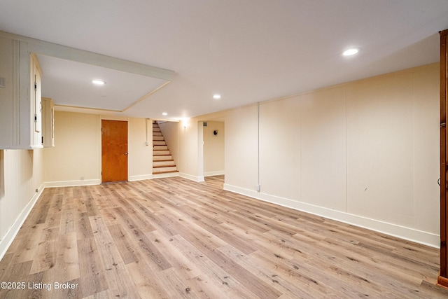 finished basement featuring stairs, light wood-type flooring, baseboards, and recessed lighting