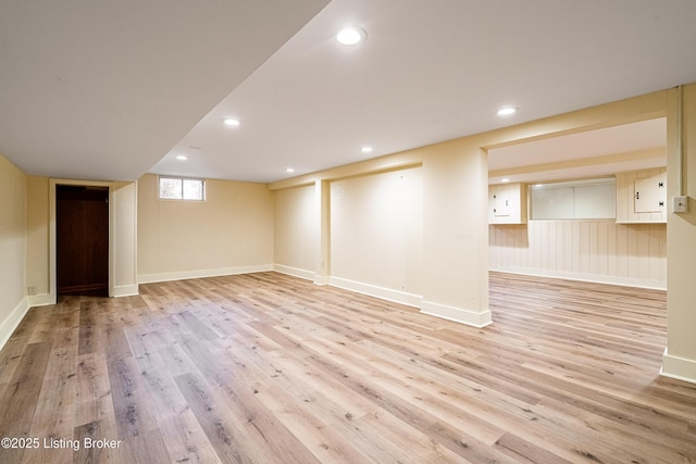 basement featuring baseboards, wood finished floors, and recessed lighting