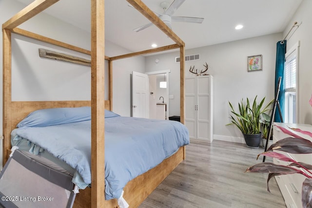bedroom with recessed lighting, visible vents, ceiling fan, wood finished floors, and baseboards