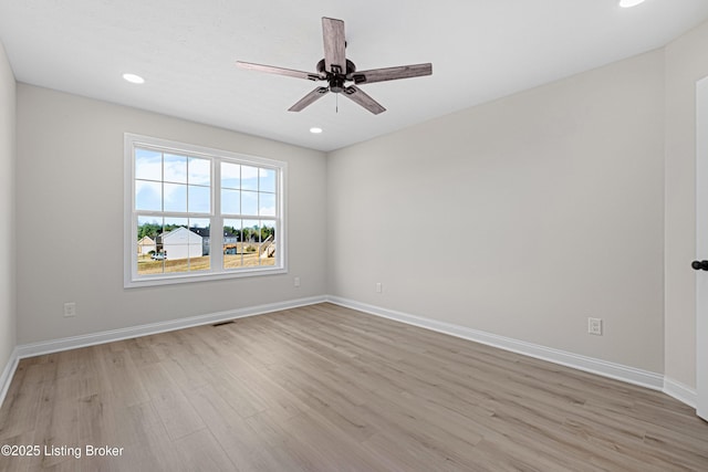 unfurnished room featuring light wood-style floors, recessed lighting, and baseboards