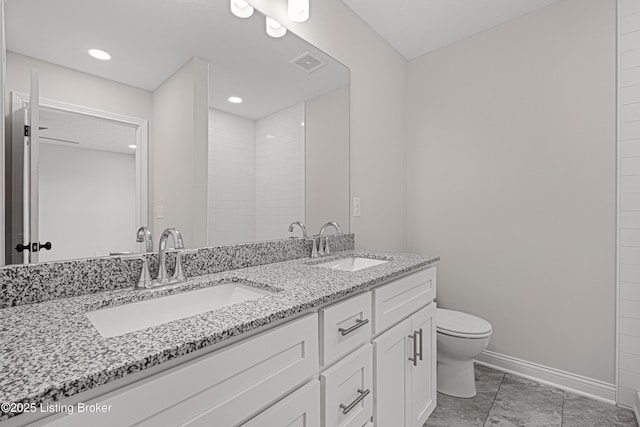 full bathroom with toilet, a sink, visible vents, and baseboards