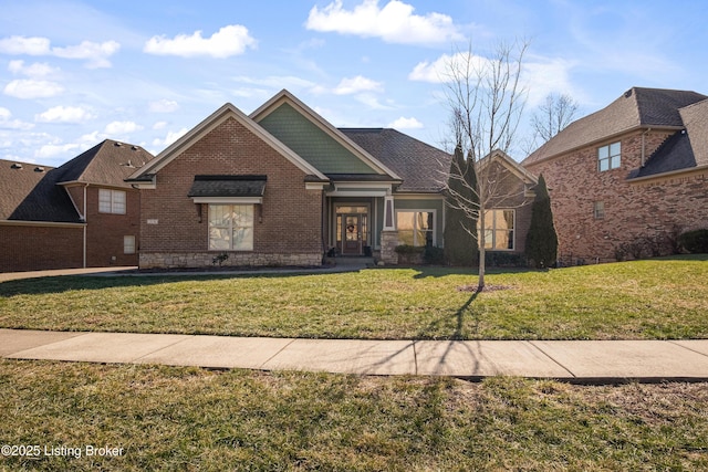 view of front of home with brick siding and a front yard