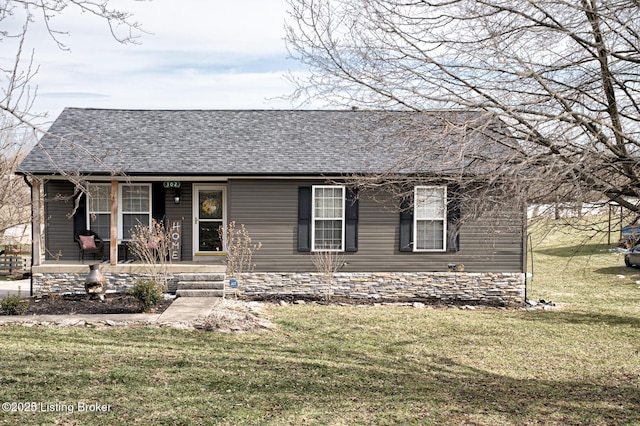 view of front of house with a shingled roof, a porch, and a front yard