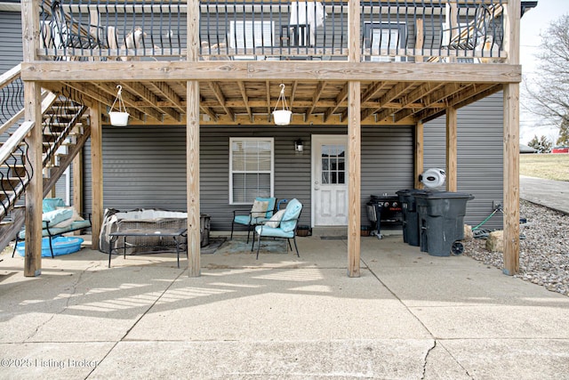 view of patio / terrace featuring a deck and stairway