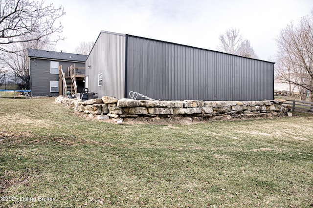 view of outdoor structure featuring a trampoline and stairway