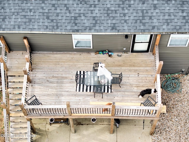 exterior space with a shingled roof and mansard roof