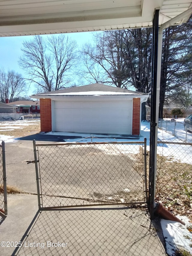 detached garage with fence and a gate