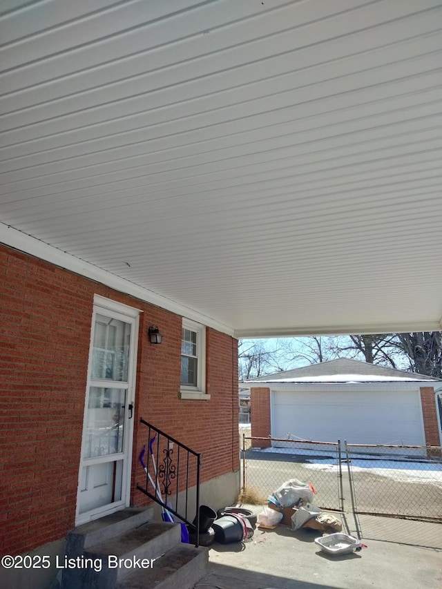 exterior space featuring fence and brick siding