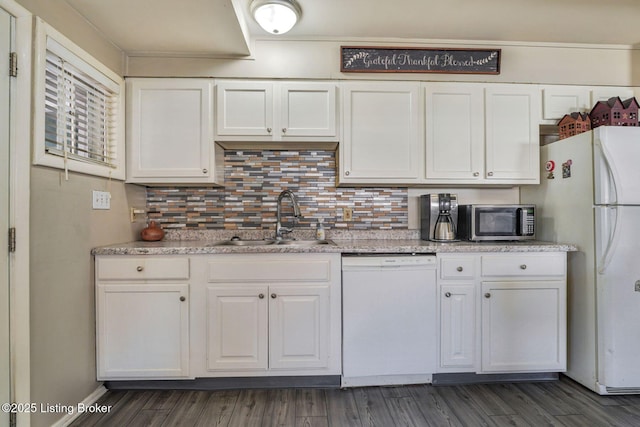 kitchen featuring dark wood-style flooring, backsplash, white cabinetry, a sink, and white appliances