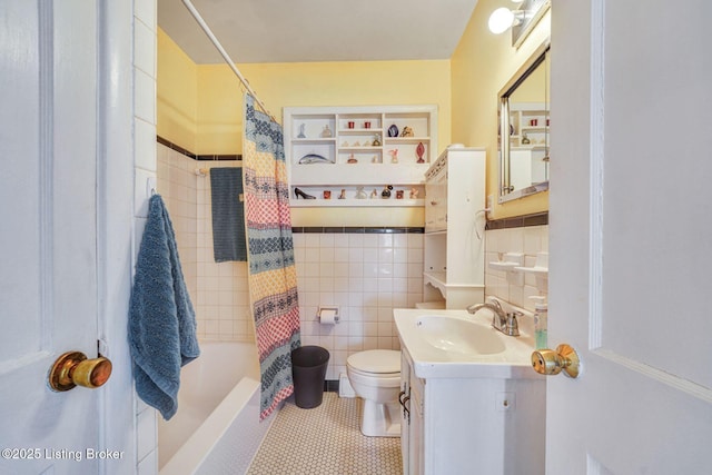 bathroom featuring tile patterned flooring, toilet, vanity, tile walls, and shower / bathtub combination with curtain