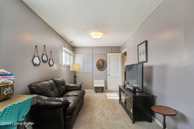 living room with light carpet, visible vents, and a textured ceiling