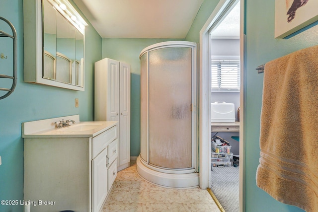 bathroom with a shower stall and vanity