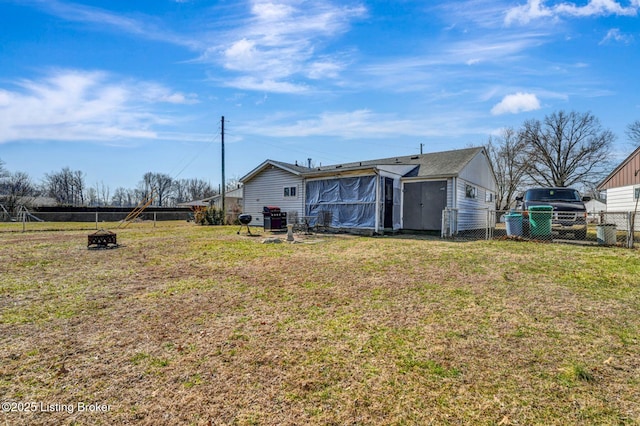 back of house featuring a lawn and fence