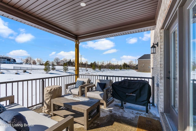 snow covered patio featuring area for grilling