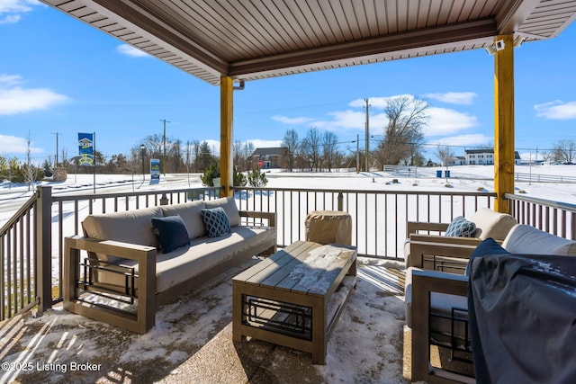 snow covered patio with an outdoor hangout area